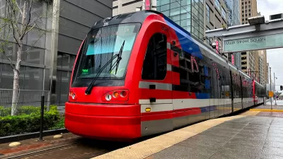 Red light rail train at outdoor platform in downtown Houston, Texas