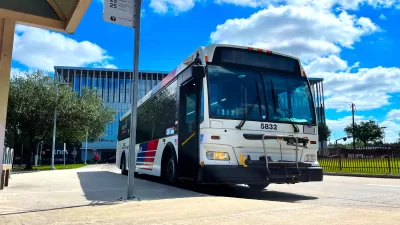 Houston Metro bus at a bus stop with bright blur cloudy sky in background