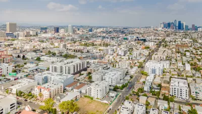 Aerial view of Koreatown neighborhood in Los Angeles with downtown skyline in background.