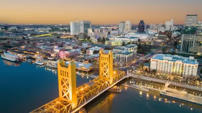 View of Tower Bridge over Sacramento River and downtown Sacramento, California at dusk.