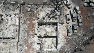 Aerial view of destroyed home and cars after Lahaina, Hawaii wildfires.