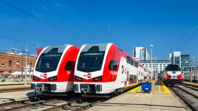 Two red and white electric trains, part of Caltrain fleet in San Francisco, California.