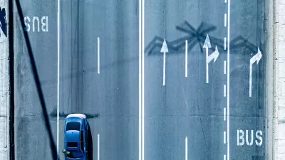 Bird's eye view of multi-lane road with dedicated bus lanes.