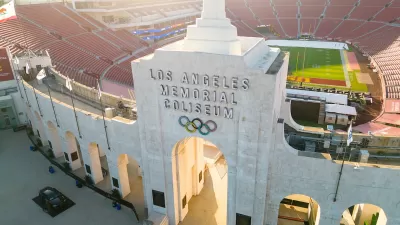 Aerial view of Los Angeles Memorial Coliseum entrance arch with name and Olympic rings.