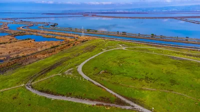 Aerial view of Sunnyvale Bay Trail on top of former landfill. Scenic view of San Francisco Bay with levees, salt marshes and sloughs.