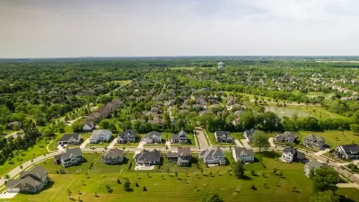 Aerial view of suburban neighborhood with large houses and green grass near Columbus, Ohio.