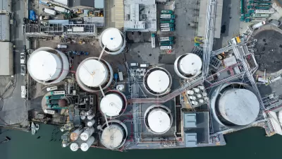 Bird's eye view of water treatment plant next to water body.