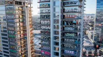 Aerial view of Oceanwide Plaza skyscrapers covered with graffiti tags.