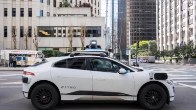 White Waymo autonomous SUV taxi on San Francisco street.