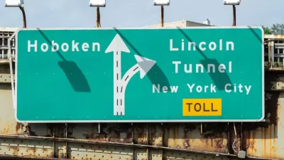 Close-up of green and white sign for Lincoln Tunnel and Hoboken.
