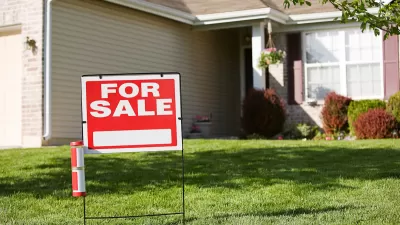 Red and white "For Sale" sign in front yard of suburban house.