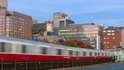 Blurred Red Line train in Boston passing on elevated rail.