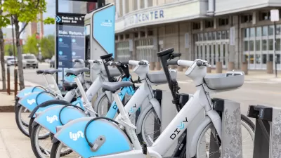 Row of silver and blue Divvy e-bikes at bike share station in Chicago, Illinois.