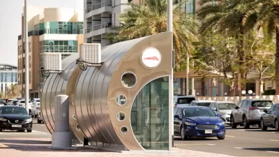 Silver and glass enclosed bus stop in Dubai.