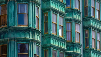 Close-up of historic building with green facade and curved windows in San Francisco, California.