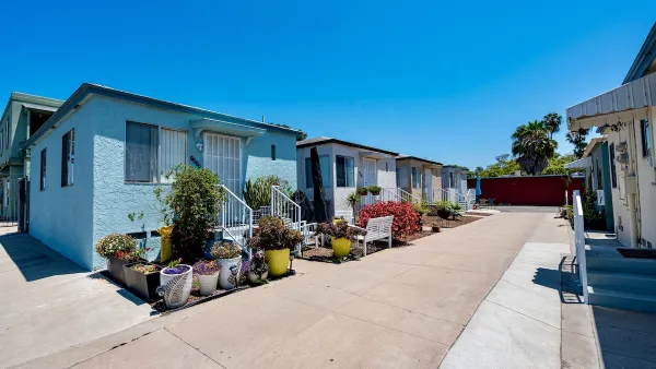 Colorful bright blue small houses with decorative cacti in courtyard in San Diego, California.