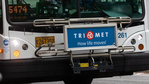 Close-up of front of Portland public bus with TriMet ad on front reading "TriMet: How Life Moves"