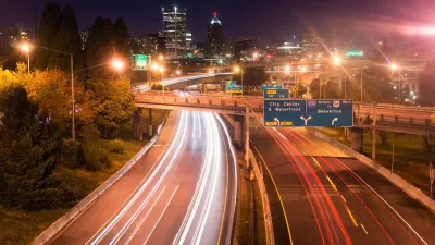 View of blurred traffic lights on Interstate 5 freeway heading into Portland, Oregon at night.