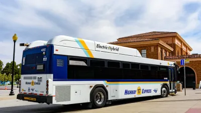 White and blue hybrid electric public transit bus in San Jose, California.