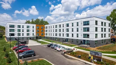 Four-story white L-shaoped apartment building with small parking lot in front in Edina, Minnesota