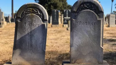 Cement gravestones reading Father and Mother
