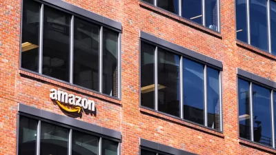 An Amazon sign adorns a brick building that implies an urban location.