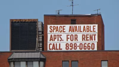 Large white banner with red letter reading "Space Available - Apts. for Rent - Call 898-0660" on brick building in Washington, D.C.