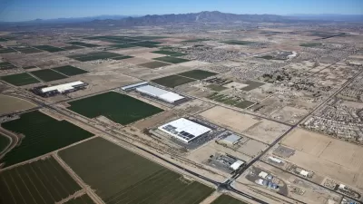 Sprawling warehouses and agricultural landscapes mix with low-rise residential developments in the Arizona desert.