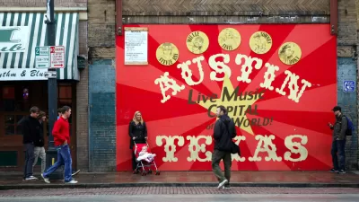 A woman with a baby in a stroller and two men are milling around in front a sign that reads Austin Texas: Live Music Capital of the World.