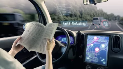 Rendering of autonomous vehicle with woman reading at the wheel