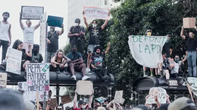 A group of protestors support Black Lives Matter and call for police reforms while gathered on top of a bus stop in Los Angeles.