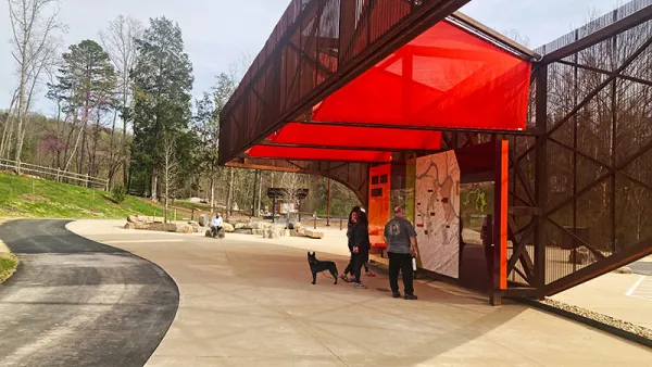 Red and black pavilion with visitor information in public park in Knoxville, Tennessee.