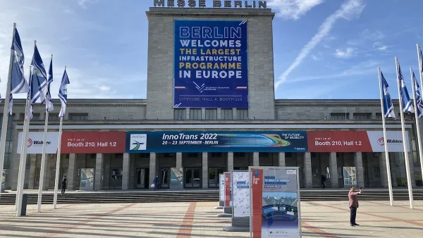 Banner welcoming Polish transit hub project at convention center in Berlin.