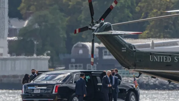 Joe Biden exits a limousine, surrounded by security and staffers, on the way to the Marine One helicopter on a pad near the water in New York City.