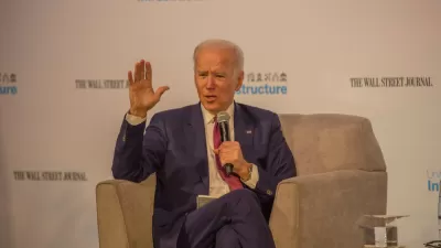 Joe Biden sits in a chair holding a microphone in front of a screen that reads Wall Street Journal and Infrastructure