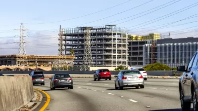 Several office towers are under construction next to a freeway in Burlingame, California.
