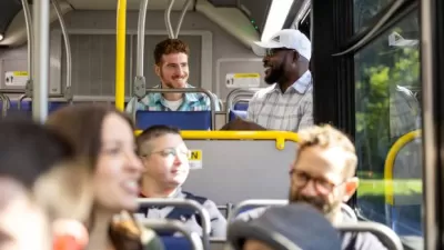 Group of cheery riders inside a CDTA public transit bus.