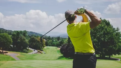 Man golfing on golf course in Watts, Los Angeles, California.