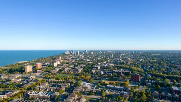 An aerial view of the South Side of Chicago, with Lake Michigan to the left in the distance. 