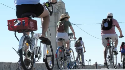 People on bikes riding across 4th Street Bridge in Los Angeles during 2010 CicLAvia event.