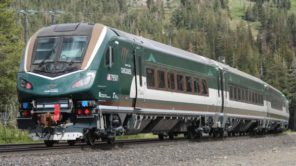 A dark green Airo train on the train tracks.