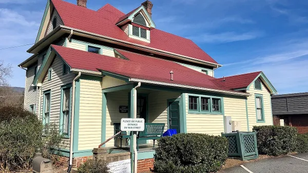 Pale yellow Sears kit house with red tile roof in Sylva, North Carolina.