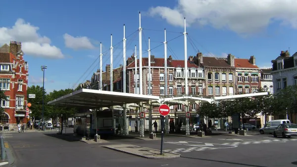 Bus station with thin white columns in Dunkirk, France.