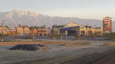 empty parking lot of Eastvale, California's best buy and kohl's, mountains in background