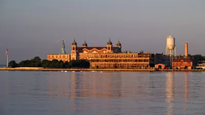 Ellis Island is shown across the water of the New York Harbor.