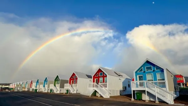 Multicolored modular emergency resnpose homes in Lahaina, Hawaii with rainbow in background.