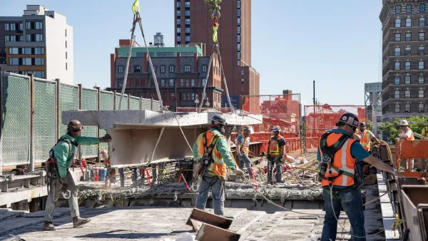 Workers in orange vests work on replacing Park Avenue Viaduct.