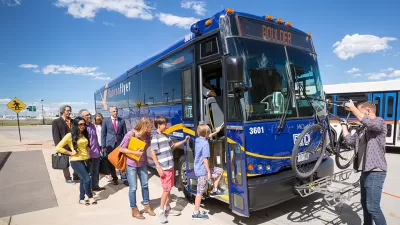 Blue Boulder bus with people boarding