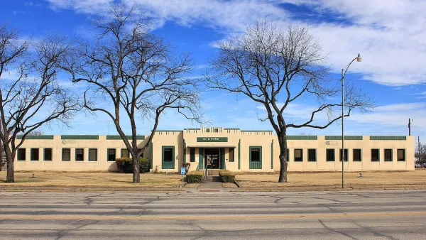 Single-story tan former hospital building in rural Baird, Texas.