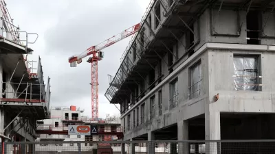Cranes rise into the sky on a construction site for an office and housing building for the Bouygues Group in the southern suburbs of Paris.